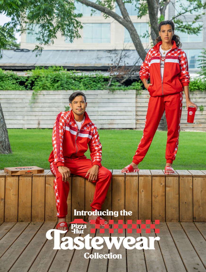 couple wearing matching red pizza hut tracksuits